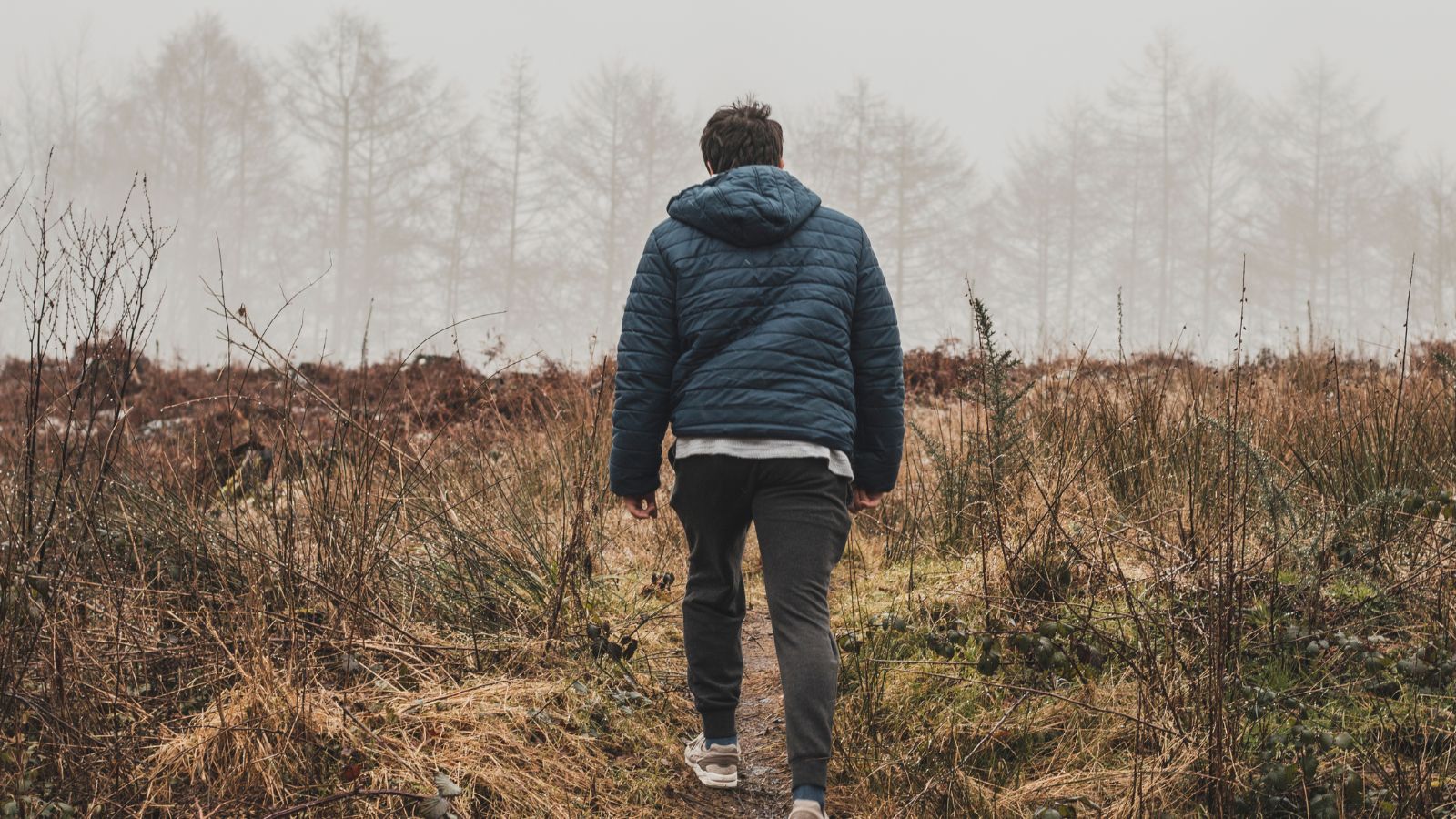 man walking up a hill